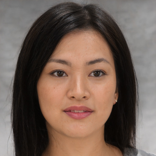 Joyful asian young-adult female with medium  brown hair and brown eyes