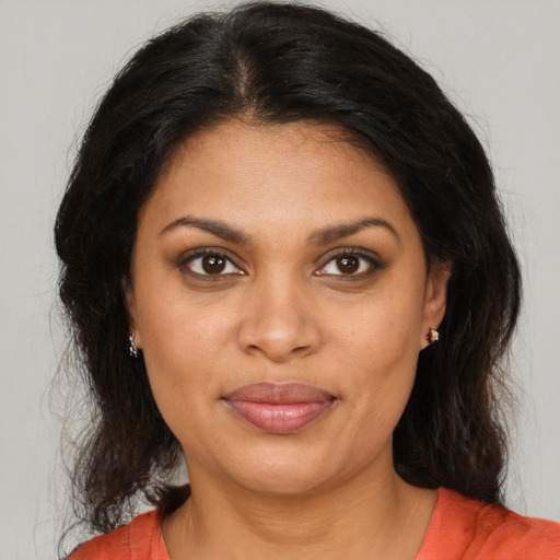 Joyful black young-adult female with medium  brown hair and brown eyes