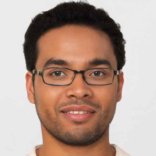 Joyful latino young-adult male with short  brown hair and brown eyes