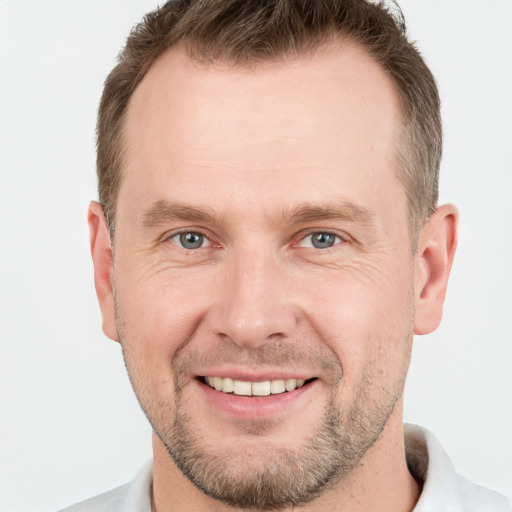 Joyful white adult male with short  brown hair and grey eyes