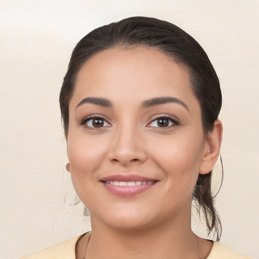 Joyful latino young-adult female with long  brown hair and brown eyes