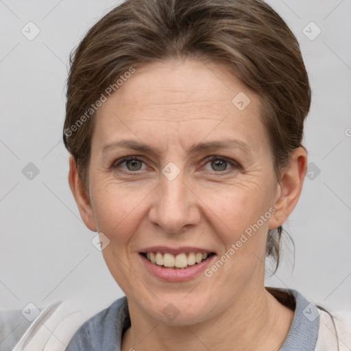 Joyful white adult female with short  brown hair and grey eyes