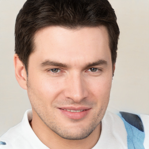 Joyful white young-adult male with short  brown hair and brown eyes