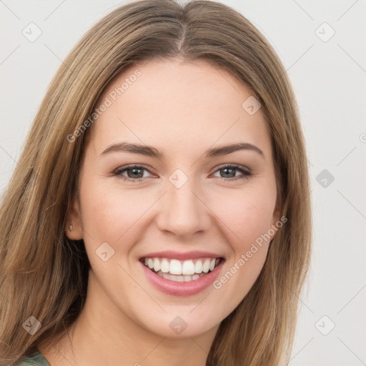 Joyful white young-adult female with long  brown hair and green eyes