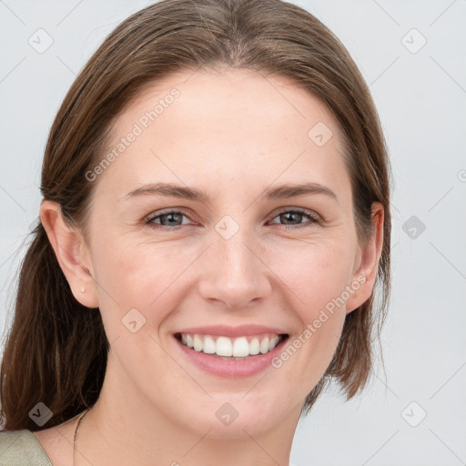 Joyful white young-adult female with medium  brown hair and blue eyes