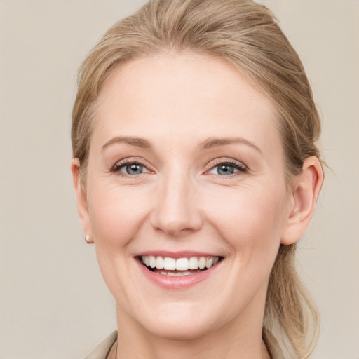 Joyful white young-adult female with medium  brown hair and grey eyes