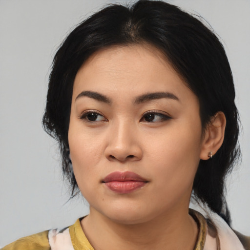 Joyful asian young-adult female with medium  black hair and brown eyes