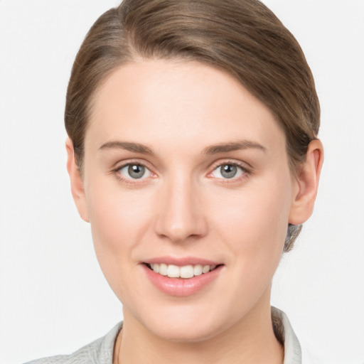 Joyful white young-adult female with medium  brown hair and grey eyes