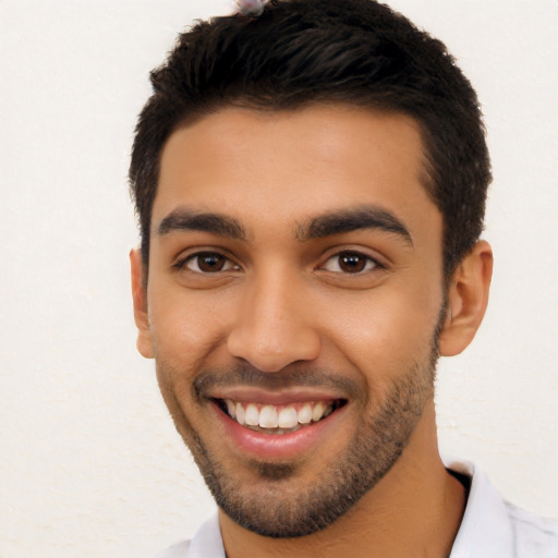 Joyful latino young-adult male with short  black hair and brown eyes