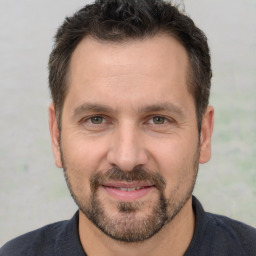 Joyful white adult male with short  brown hair and brown eyes