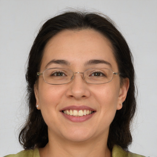 Joyful white adult female with medium  brown hair and brown eyes