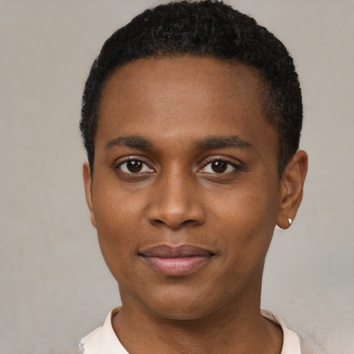 Joyful black young-adult male with short  black hair and brown eyes