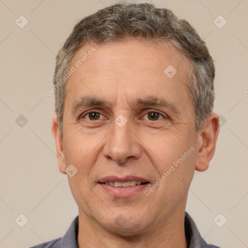 Joyful white adult male with short  brown hair and brown eyes