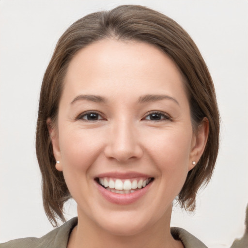 Joyful white young-adult female with medium  brown hair and grey eyes