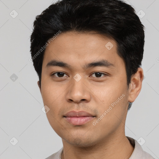 Joyful asian young-adult male with short  black hair and brown eyes