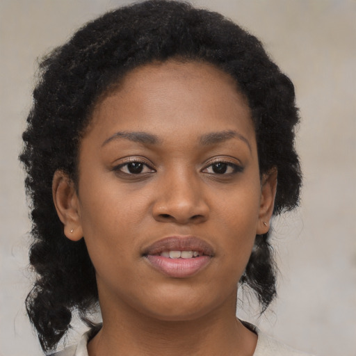 Joyful black young-adult female with medium  black hair and brown eyes