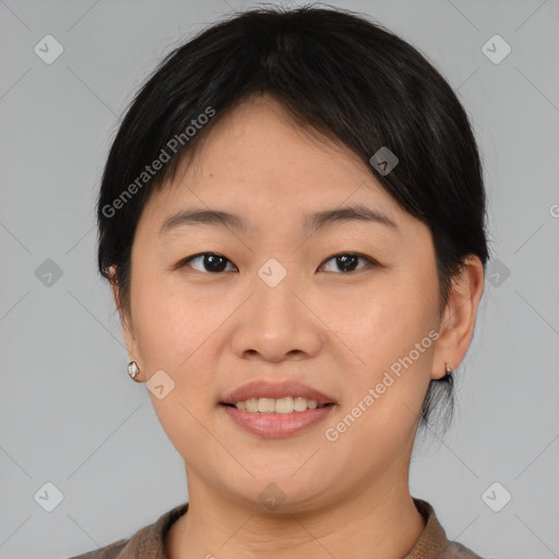 Joyful asian young-adult female with medium  brown hair and brown eyes