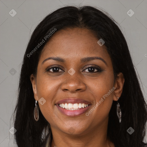 Joyful black young-adult female with long  brown hair and brown eyes