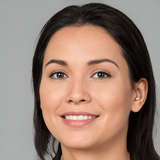 Joyful white young-adult female with long  black hair and brown eyes