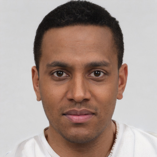 Joyful latino young-adult male with short  brown hair and brown eyes