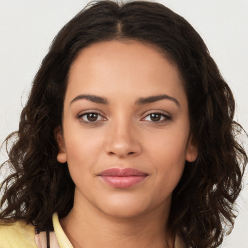 Joyful latino young-adult female with long  brown hair and brown eyes