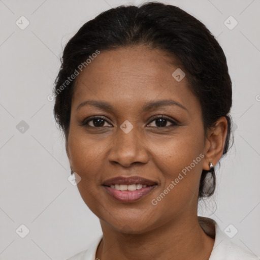 Joyful black adult female with short  brown hair and brown eyes