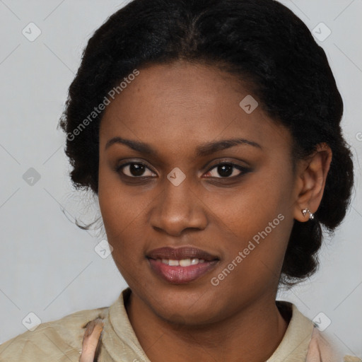 Joyful black young-adult female with long  black hair and brown eyes