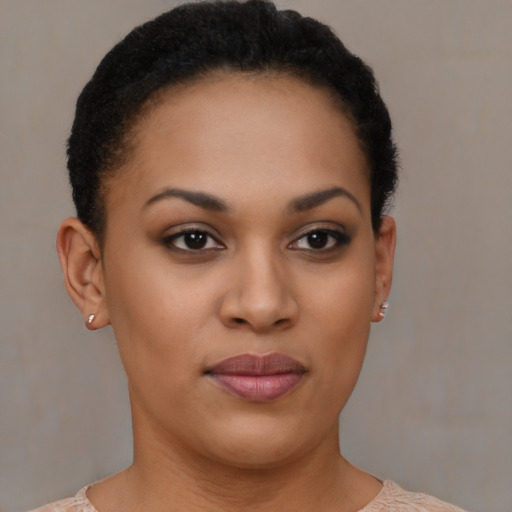 Joyful black young-adult female with short  brown hair and brown eyes