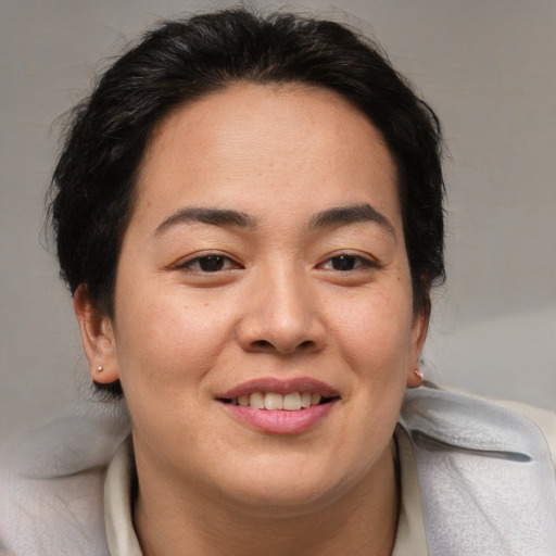 Joyful white adult female with medium  brown hair and brown eyes