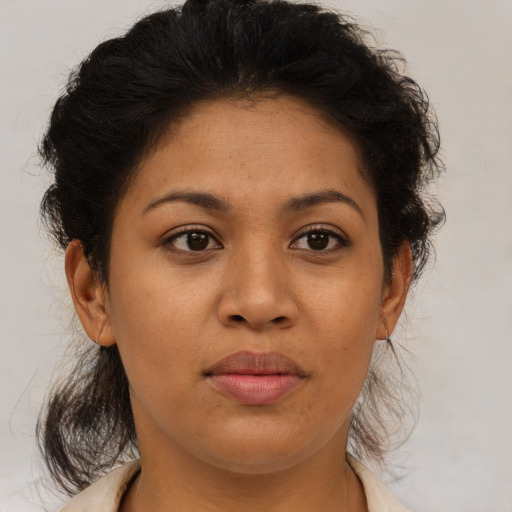Joyful latino adult female with medium  brown hair and brown eyes