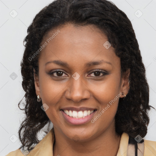 Joyful black young-adult female with long  brown hair and brown eyes