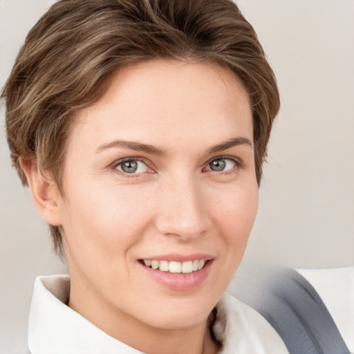 Joyful white young-adult female with short  brown hair and grey eyes