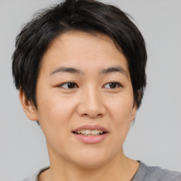 Joyful asian young-adult female with short  brown hair and brown eyes