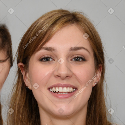 Joyful white young-adult female with long  brown hair and grey eyes