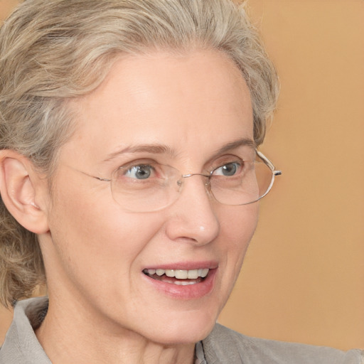 Joyful white middle-aged female with medium  blond hair and blue eyes