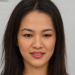 Joyful asian young-adult female with long  brown hair and brown eyes