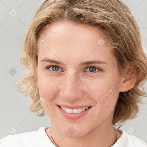 Joyful white young-adult female with medium  brown hair and blue eyes