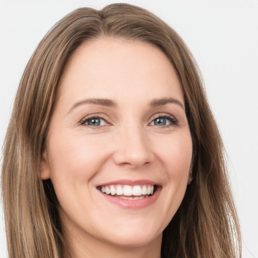 Joyful white young-adult female with long  brown hair and grey eyes