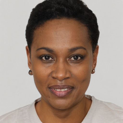 Joyful black young-adult female with short  black hair and brown eyes