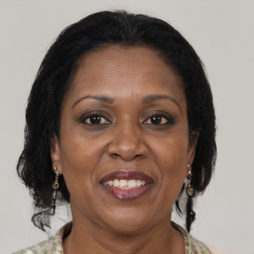 Joyful black adult female with medium  brown hair and brown eyes