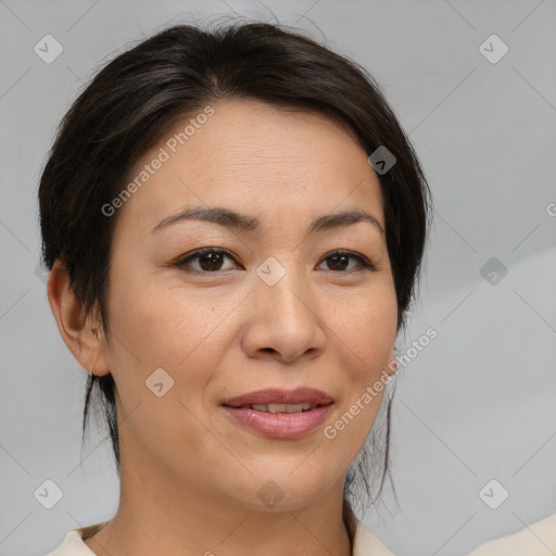 Joyful asian adult female with medium  brown hair and brown eyes