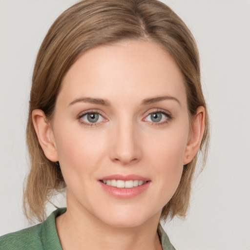 Joyful white young-adult female with medium  brown hair and grey eyes