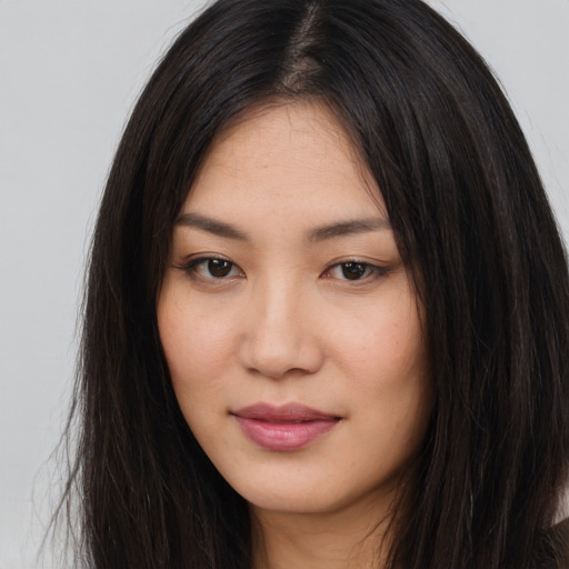 Joyful asian young-adult female with long  brown hair and brown eyes