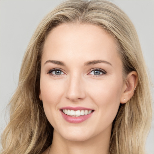 Joyful white young-adult female with long  brown hair and grey eyes