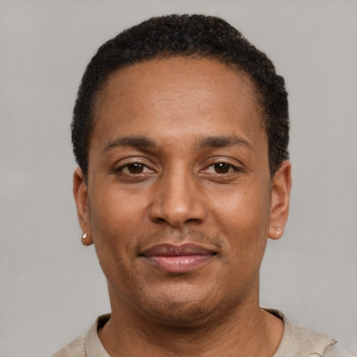 Joyful latino young-adult male with short  brown hair and brown eyes