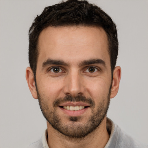 Joyful white young-adult male with short  black hair and brown eyes