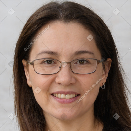 Joyful white adult female with long  brown hair and grey eyes