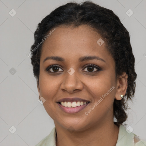 Joyful black young-adult female with long  brown hair and brown eyes