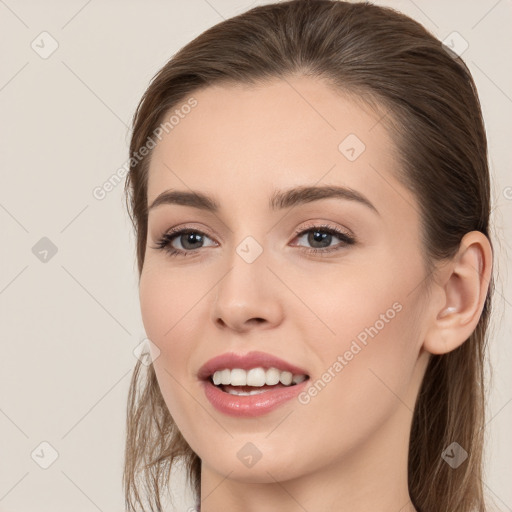 Joyful white young-adult female with long  brown hair and brown eyes