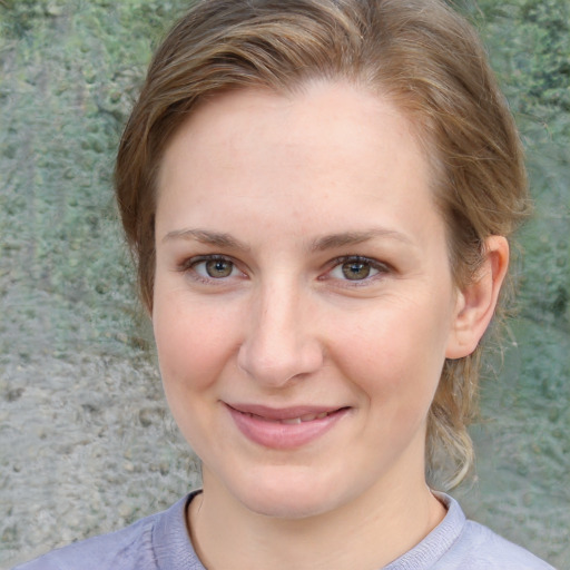 Joyful white young-adult female with medium  brown hair and blue eyes